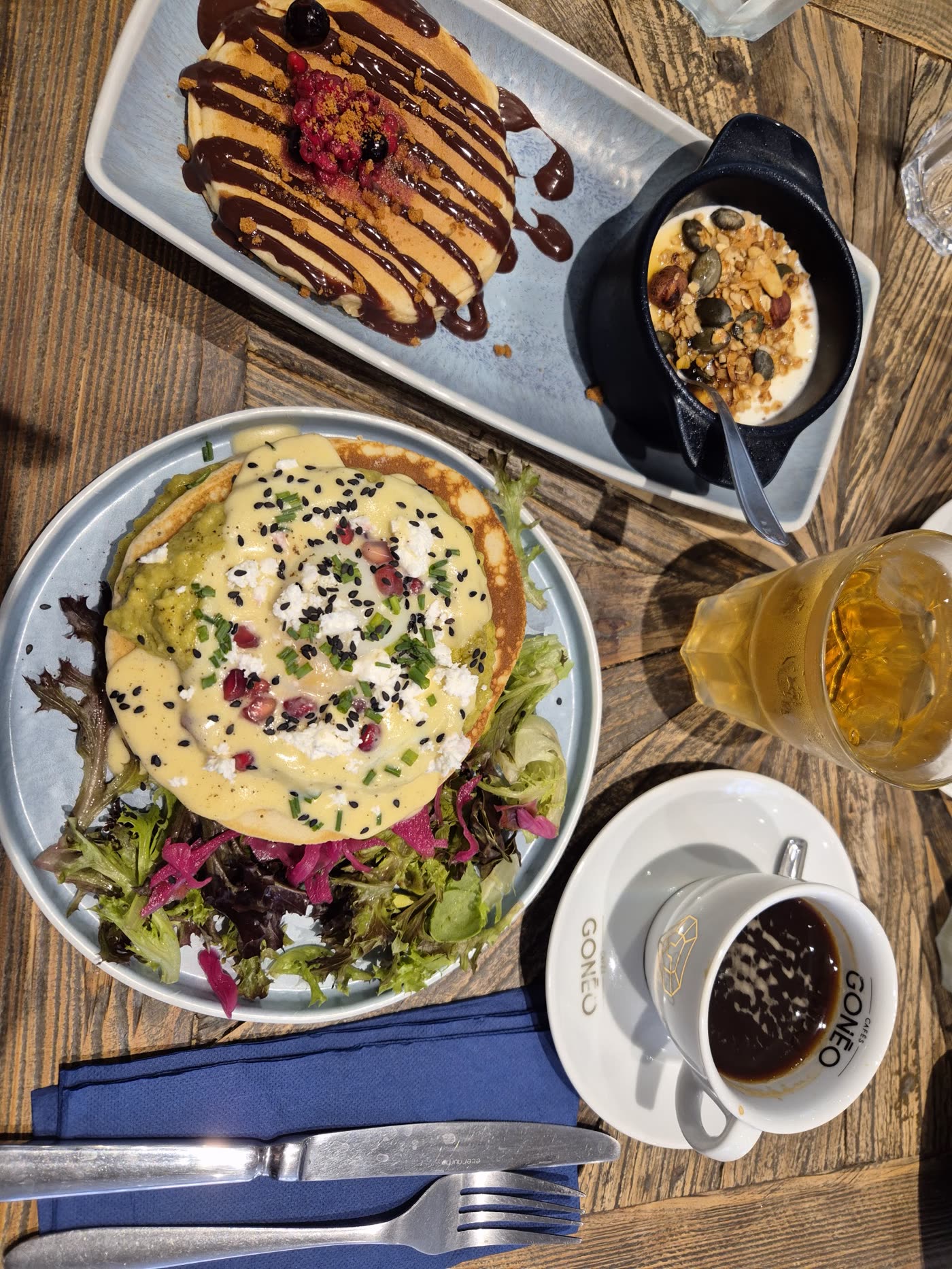 Vue de dessus d'une table de brunch : pancakes, granola bowl et café